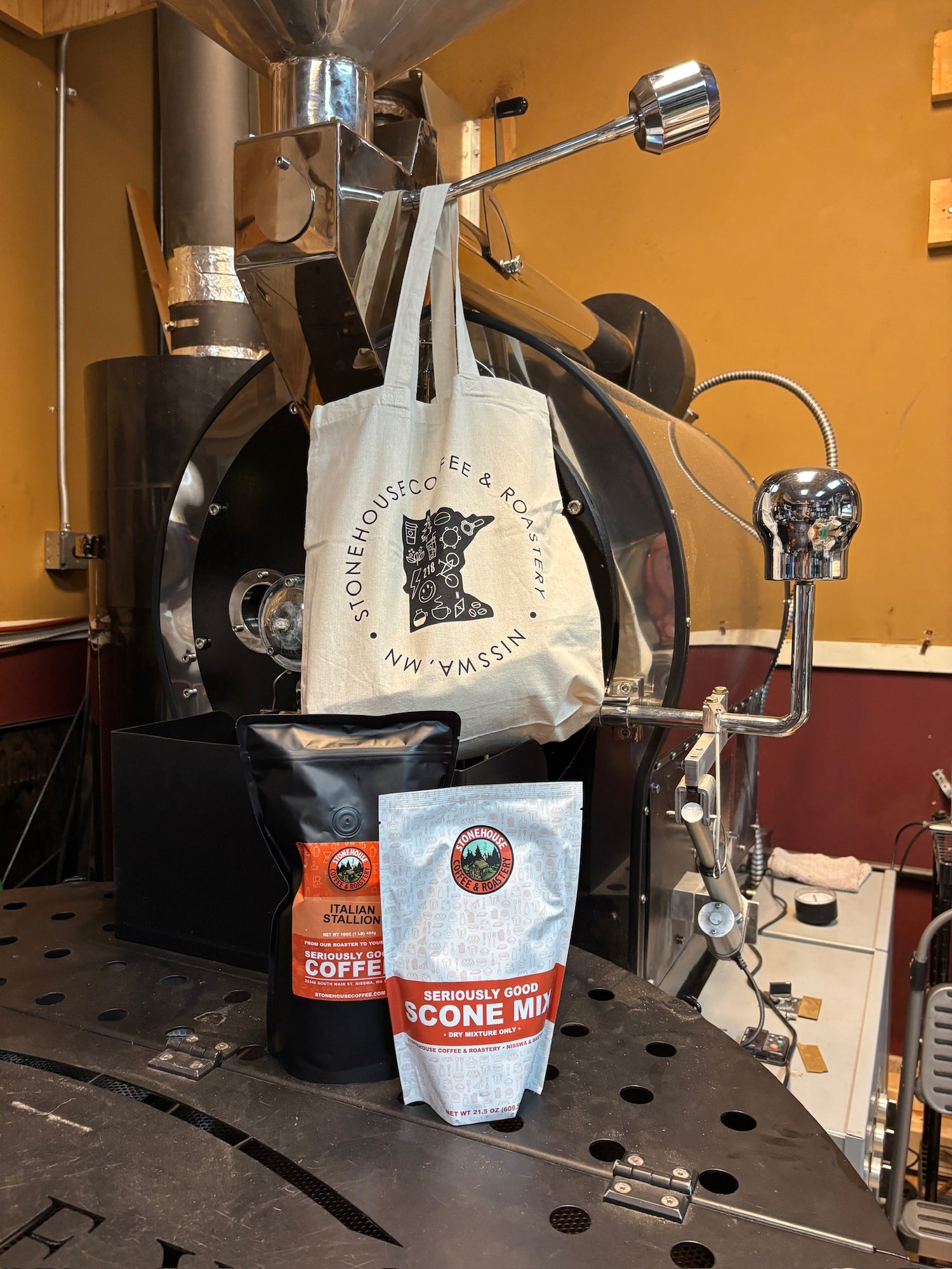 Coffee roaster with bags of coffee and scone mix.